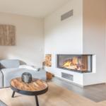 Living room with sofa, fireplace, and wooden table.