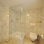 Bathroom with shower, toilet, and window