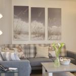 Living room with sofa, coffee table, and wall art.