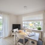 Dining room with table, chairs, and view of garden