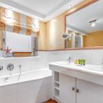 Bath with bathtub, double sink, and mirror