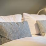 Bed headboard with pillows and reading lamp