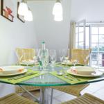 Round glass table with chairs and placemats