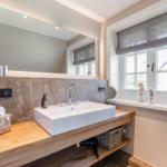 Sink with mirror and window with seahorse figurines