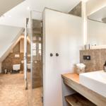 Bathroom with shower, bathtub, and sink.
