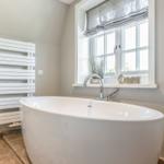 Freestanding bathtub with window and heater