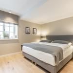Bedroom with double bed, window, and bedside table