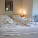 Bedroom with double bed, two nightstands, and wall decoration.