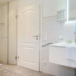 Bathroom with shower, sink, and mirror