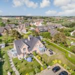 House with large garden and terrace. View of residential area and landscape.