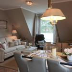 Living and dining area with sofa, dining table, and window