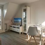 Living area with dining table, TV, and window with view