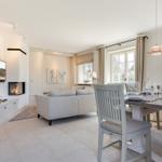 Wohn- und Essbereich mit Sofa, Esstisch und Kamin