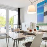 Dining room with table, chairs, and view of balcony