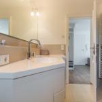 Bathroom with sink, mirror, and radiator