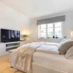 Bedroom with bed, TV, and window