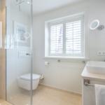 Bathroom with shower, toilet, and sink.