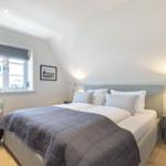 Bedroom with double bed, nightstand, and window view.