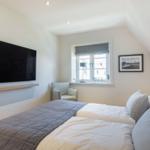 Bedroom with double bed, TV, and window