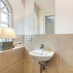 Bathroom with sink, mirror, and window