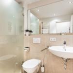 Bathroom with shower, toilet, and sink.