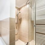 Bath with shower, bathtub, and heater