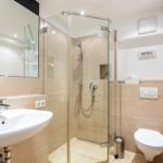 Bathroom with shower, sink, and toilet.