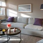Living room with sofa, table, and wall art.