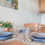 Table set with blue plates, glasses, and flower arrangement.