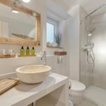 Bathroom with shower, sink, and mirror