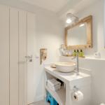 Bathroom with sink, mirror, and window