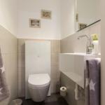 Badezimmer mit Toilette, Waschbecken und Handtuchhalter