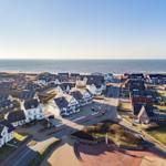 Aerial view of coastal village with houses near sea.