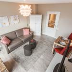 Living room with sofa, dining table, and white cabinets