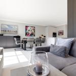 Living room with sofa, dining table, and wall art