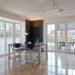 Dining room with table, chairs, and view of garden.