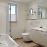Bath with bathtub, shower, sink, and mirror