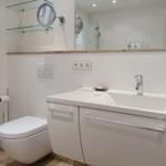 Bathroom with sink, toilet, and mirror