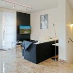 Living room with sofa, TV, and terrace door.