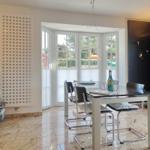 Dining room with glass top, chairs, and windows to the outside.