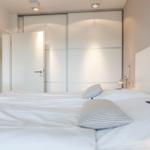 Bedroom with bed, closet, and lamp