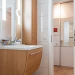 Bathroom with sink, mirror, and towel warmer