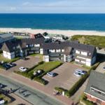 Property with beachfront, parking, and green areas