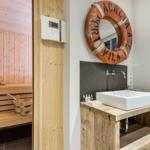 Bathroom with sink and sauna in the background
