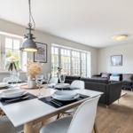 Dining area with table and chairs, living area with sofa and TV