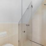 Dusche mit Glaswand und Duschbrause an der Wand
