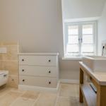 Bathroom with sink, toilet, and cabinet