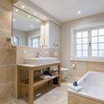 Bathroom with shower, bathtub, sink, and window
