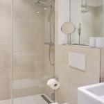 Bathroom with shower, sink, and mirror