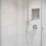 Shower cabin with glass door and chrome shower head